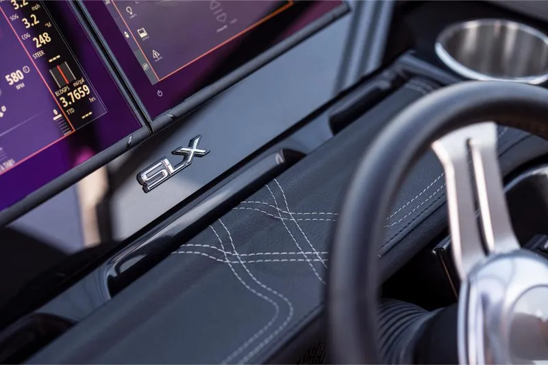 Slide: The Image of Close-up of 2023 Sea Ray SLX 260 dashboard with digital displays and steering wheel. - 19