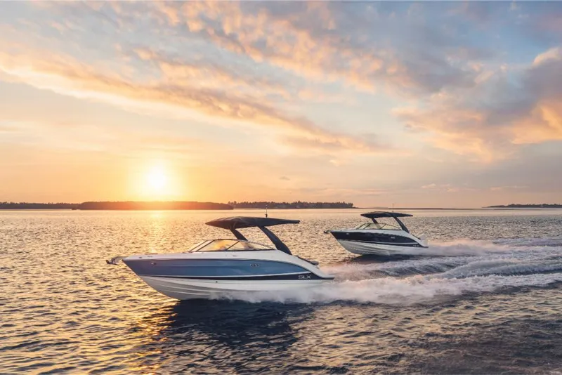 Slide: The Image of 2023 Sea Ray SLX 260 boats cruising at sunset on open water. - 29