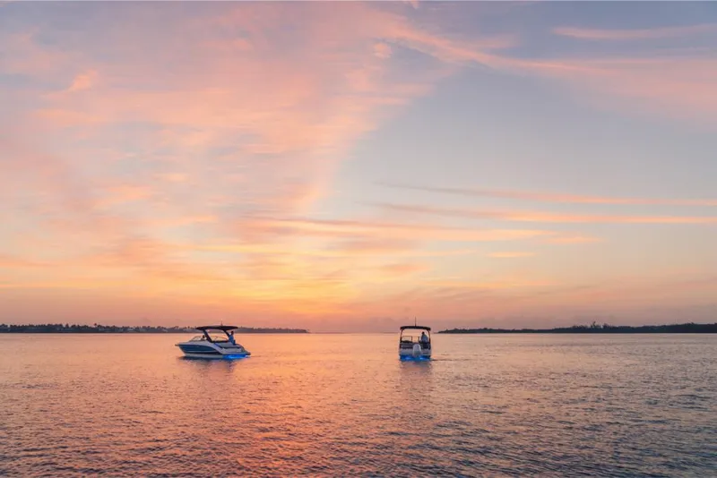 Slide: The Image of 2023 Sea Ray SLX 260 boats on serene water at sunset. - 31