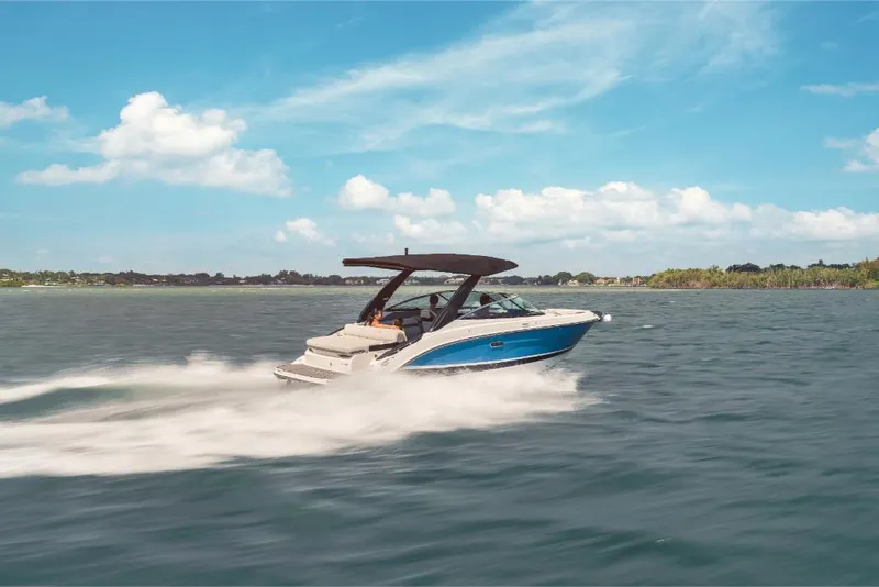 Slide: The Image of 2023 Sea Ray SLX 260 boat cruising on a sunny day. - 4