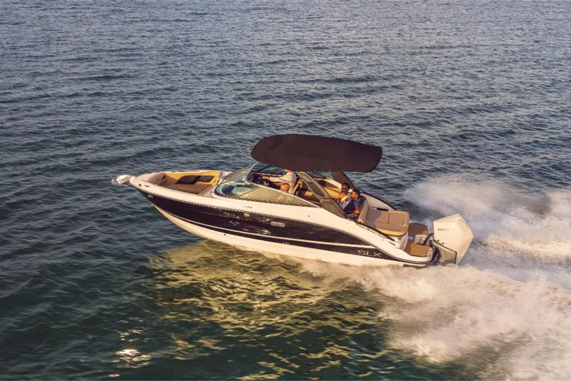 Slide: The Image of 2023 Sea Ray SLX 260 OB cruising on open water. - 2