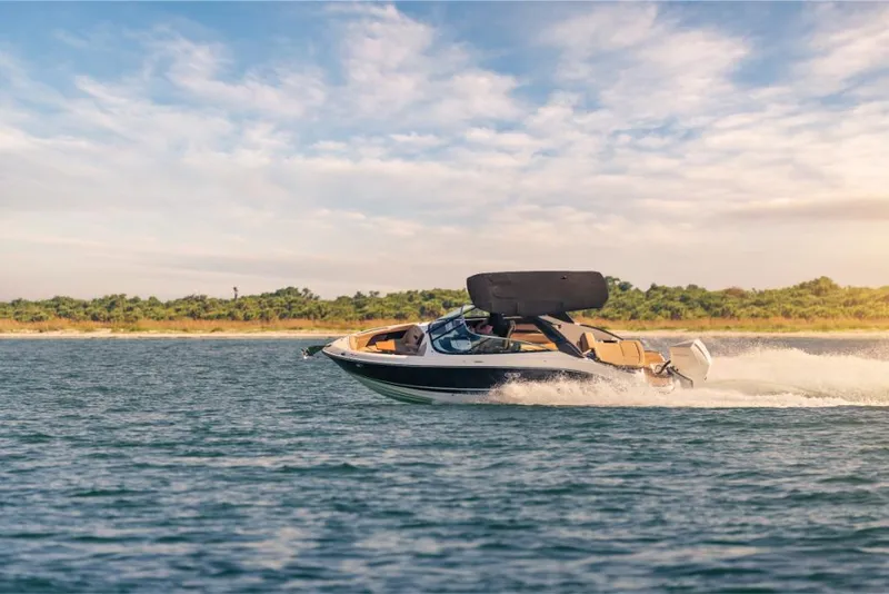 Slide: The Image of 2023 Sea Ray SLX 260 OB cruising on a sunny day. - 22