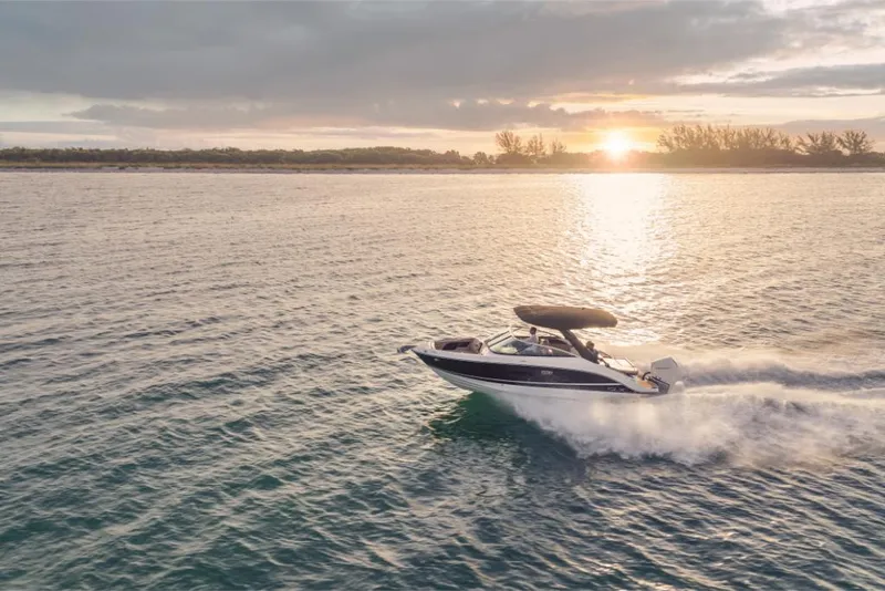Slide: The Image of 2023 Sea Ray SLX 260 OB cruising at sunset on open water. - 8