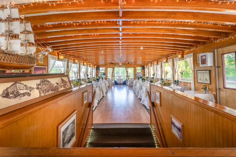 Slide: The Image of Interior of 1990 Custom Howdy Eidelman Sternwheeler, featuring elegant dining setup and wooden decor. - 11