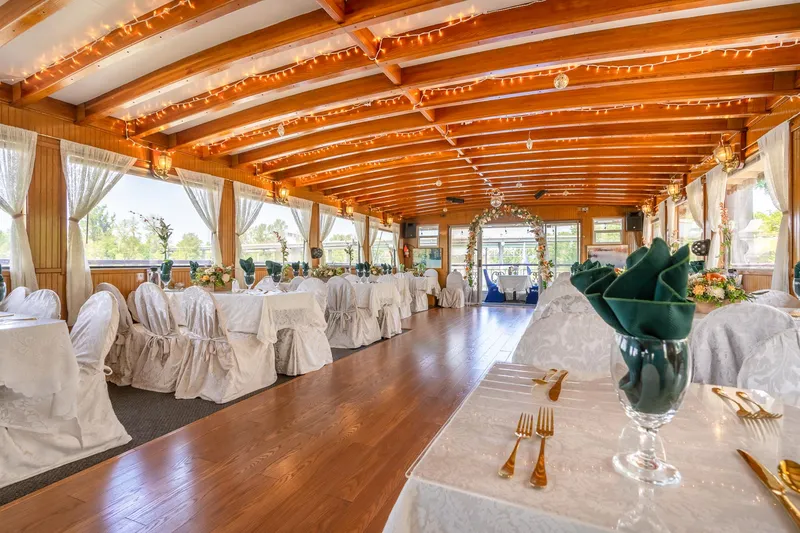 Slide: The Image of Elegant dining area on 1990 Custom Howdy Eidelman Sternwheeler, featuring decorated tables and wooden beams. - 14