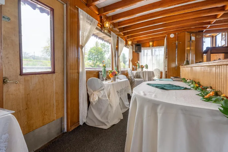 Slide: The Image of Elegant interior of 1990 Howdy Eidelman Sternwheeler, featuring decorated tables and wooden beams. - 20