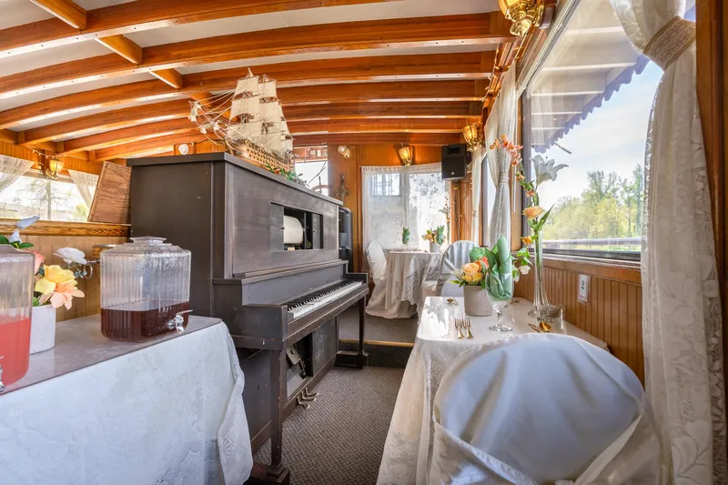 Slide: The Image of Elegant interior of 1990 Custom Howdy Eidelman Sternwheeler with piano and decorated tables. - 24
