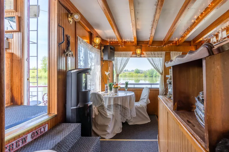 Slide: The Image of Cozy interior of 1990 Custom Howdy Eidelman Sternwheeler with dining area and river view. - 25