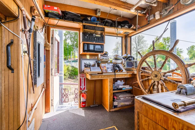 Slide: The Image of Wheelhouse of 1990 Custom Howdy Eidelman Sternwheeler, featuring wooden interior and navigational equipment. - 30