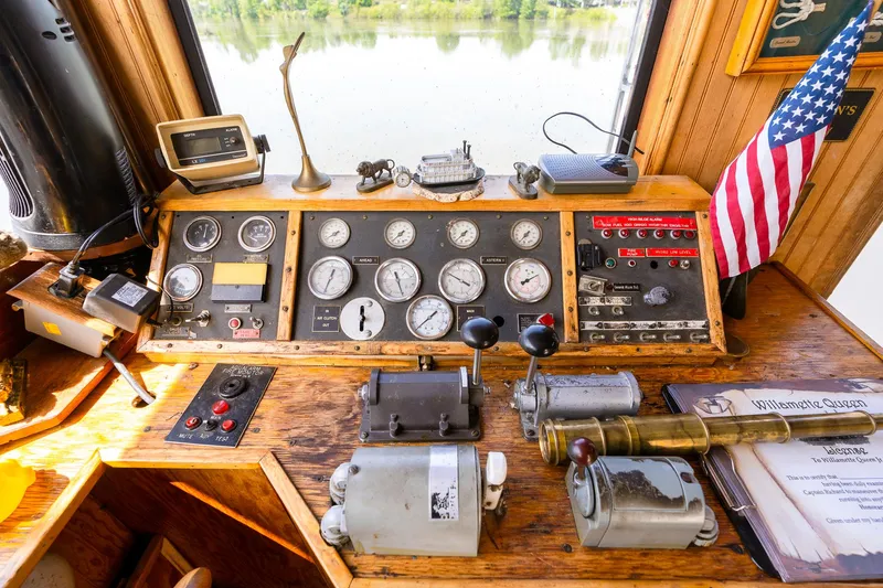 Slide: The Image of Control panel of 1990 Custom Howdy Eidelman Sternwheeler, featuring gauges and American flag. - 34