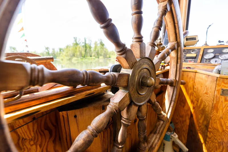 Slide: The Image of Wooden ship wheel on 1990 Custom Howdy Eidelman Sternwheeler, Jack Sarin design. - 37