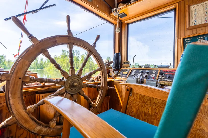 Slide: The Image of Wooden helm of 1990 Custom Howdy Eidelman Sternwheeler, showcasing vintage nautical controls. - 38