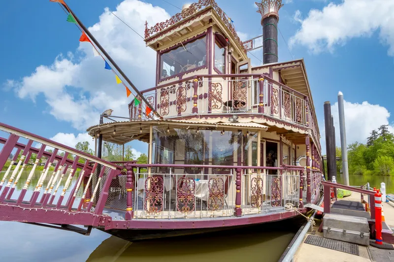 Slide: The Image of Vintage 1990 Howdy Eidelman Sternwheeler boat docked, featuring ornate design and colorful flags. - 4