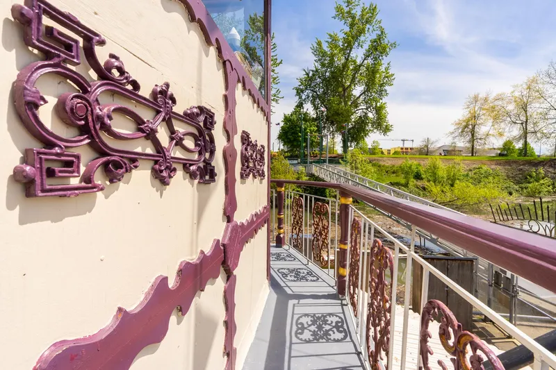 Slide: The Image of Ornate deck of 1990 Custom Howdy Eidelman Sternwheeler, featuring intricate railings and scenic view. - 41