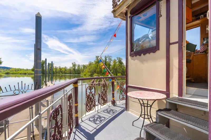 Slide: The Image of Sunny deck of 1990 Howdy Eidelman Sternwheeler with ornate railing and river view. - 43