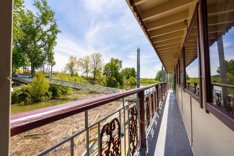 Slide: The Image of Side view of 1990 Howdy Eidelman Sternwheeler, showcasing deck and scenic river landscape. - 46
