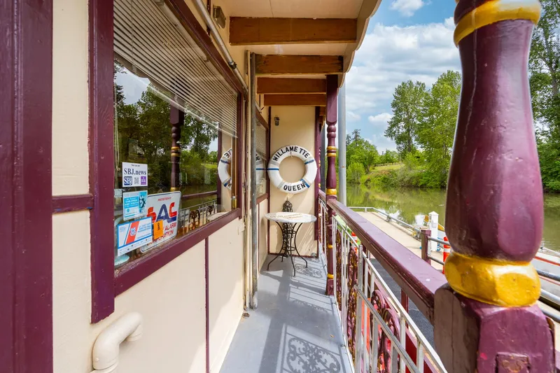 Slide: The Image of Exterior view of 1990 Custom Howdy Eidelman Sternwheeler, featuring deck and river scenery. - 5