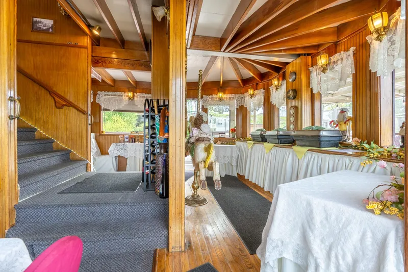 Slide: The Image of Interior of 1990 Custom Howdy Eidelman Sternwheeler, featuring elegant decor and buffet setup. - 8