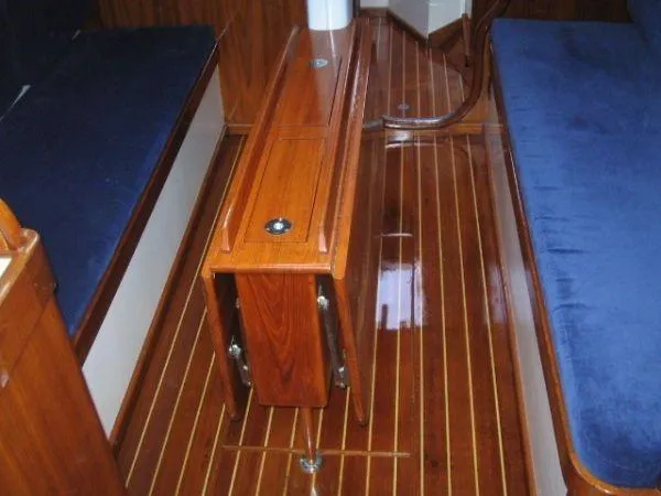 Slide: The Image of Interior of 1979 Palmer Johnson New York 40 Sloop with polished wood and blue seating. - 10