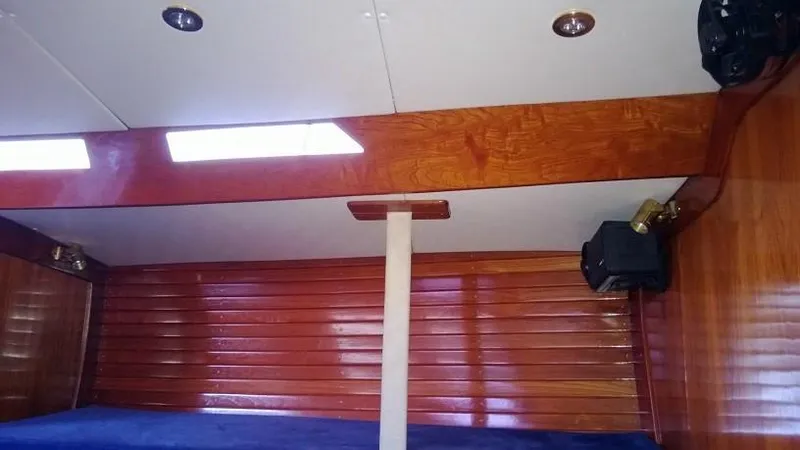 Slide: The Image of Interior of 1979 Palmer Johnson New York 40 Sloop with wooden paneling and skylights. - 12