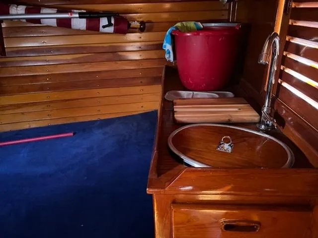 Slide: The Image of Interior of 1979 Palmer Johnson New York 40 Sloop with wooden cabinetry and blue carpet. - 22