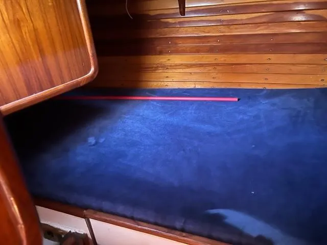 Slide: The Image of Interior of 1979 Palmer Johnson New York 40 Sloop with wooden paneling and blue upholstery. - 23