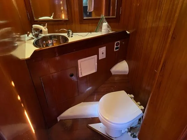 Slide: The Image of 1979 Palmer Johnson New York 40 Sloop bathroom with wooden interior and compact fixtures. - 28