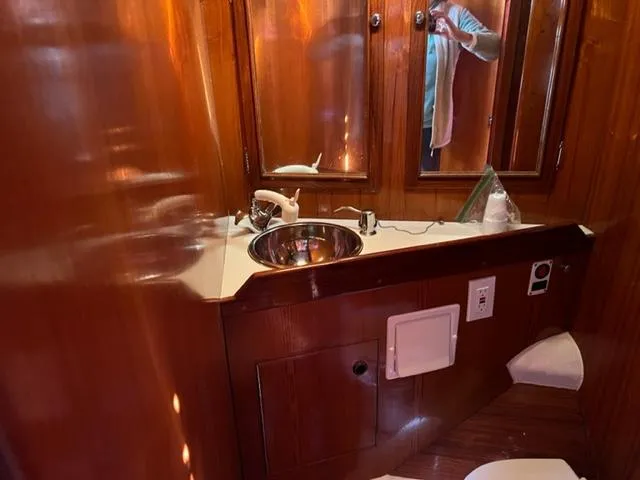 Slide: The Image of 1979 Palmer Johnson New York 40 Sloop bathroom with wooden cabinetry and stainless steel sink. - 29