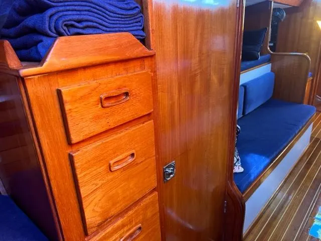 Slide: The Image of Interior of 1979 Palmer Johnson New York 40 Sloop with wooden cabinetry and blue seating. - 31