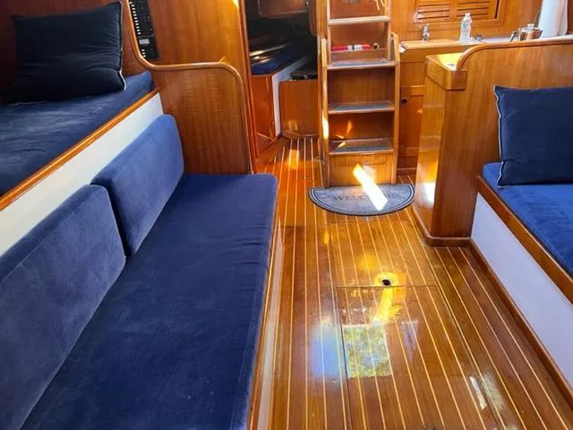 Slide: The Image of Interior of 1979 Palmer Johnson New York 40 Sloop with wooden flooring and blue seating. - 32