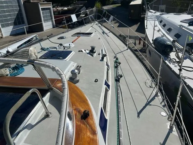 Slide: The Image of 1979 Palmer Johnson New York 40 Sloop deck, showcasing rigging and equipment in a marina setting. - 37