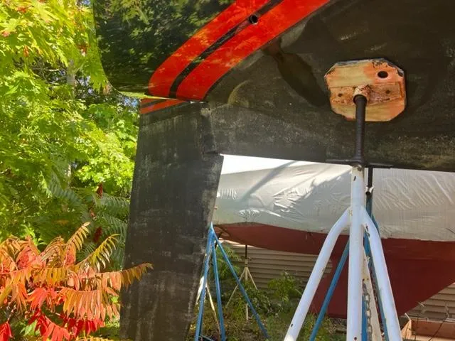 Slide: The Image of 1979 Palmer Johnson New York 40 Sloop keel and rudder, surrounded by greenery. - 45