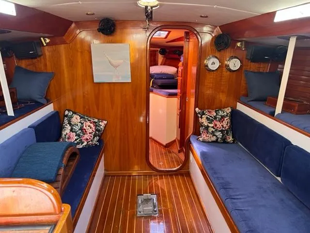 Slide: The Image of Interior of 1979 Palmer Johnson New York 40 Sloop with wooden finish and blue seating. - 5