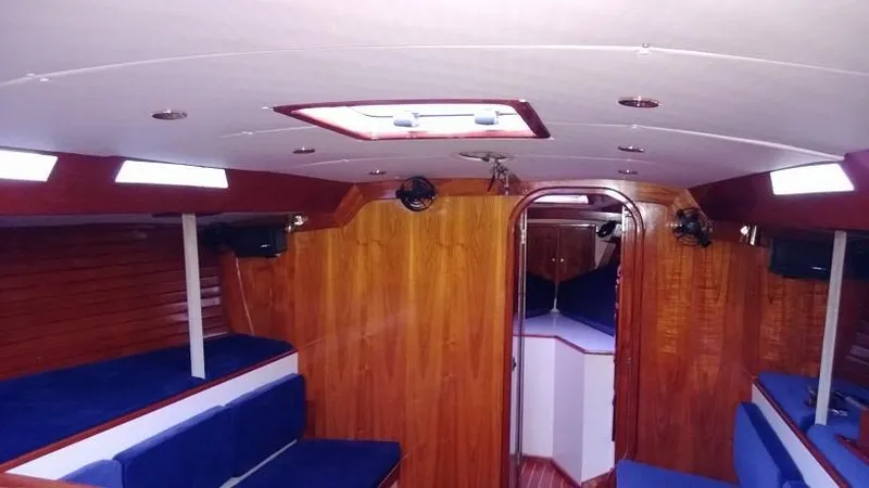 Slide: The Image of Interior of 1979 Palmer Johnson New York 40 Sloop with wooden finish and blue seating. - 8