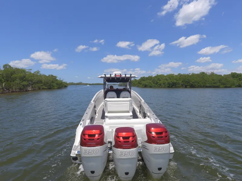 The Image of 2017 Nor-Tech 390 Sport boat with triple outboard engines on a sunny day. - 1