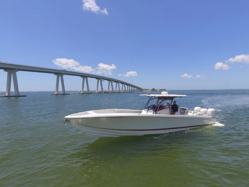 Slide: The Image of 2017 Nor-Tech 390 Sport boat cruising near a bridge on a sunny day. - 17