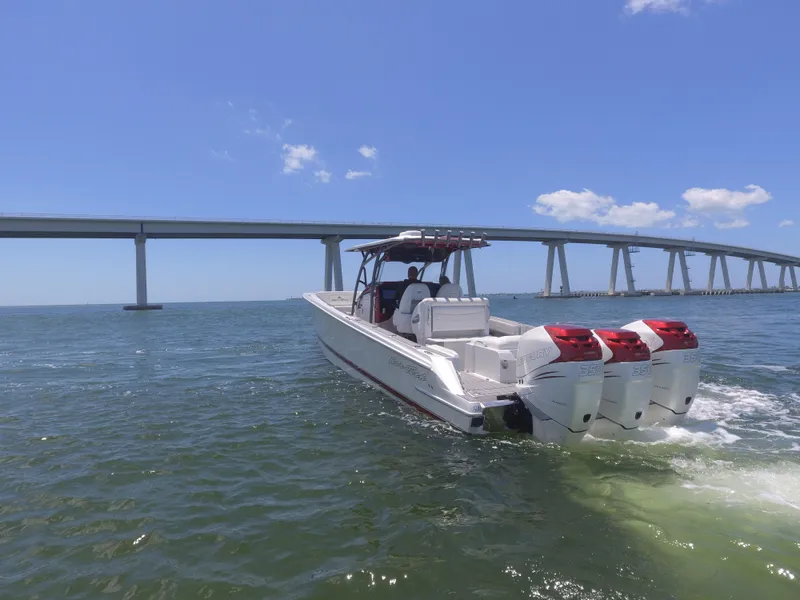 Slide: The Image of 2017 Nor-Tech 390 Sport boat cruising under a bridge on a sunny day. - 20