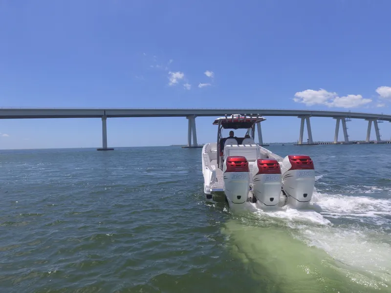 Slide: The Image of 2017 Nor-Tech 390 Sport boat cruising under a bridge on a sunny day. - 21