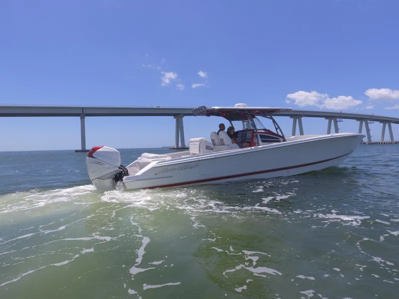 Slide: The Image of 2017 Nor-Tech 390 Sport boat cruising under a bridge on a sunny day. - 24