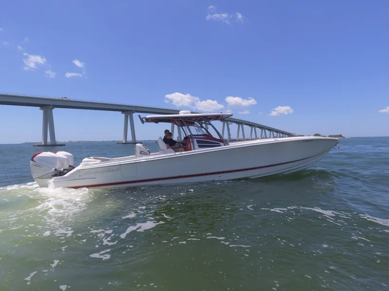 Slide: The Image of 2017 Nor-Tech 390 Sport boat cruising under a bridge on a sunny day. - 25