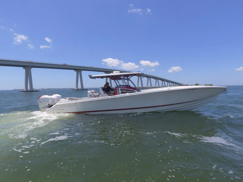 Slide: The Image of 2017 Nor-Tech 390 Sport boat cruising under a bridge on a sunny day. - 26