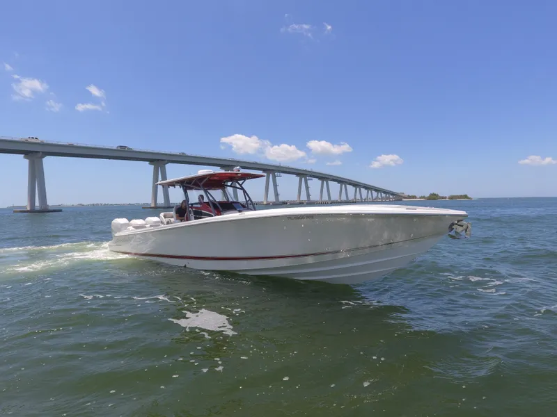 Slide: The Image of 2017 Nor-Tech 390 Sport boat cruising under a bridge on a sunny day. - 28
