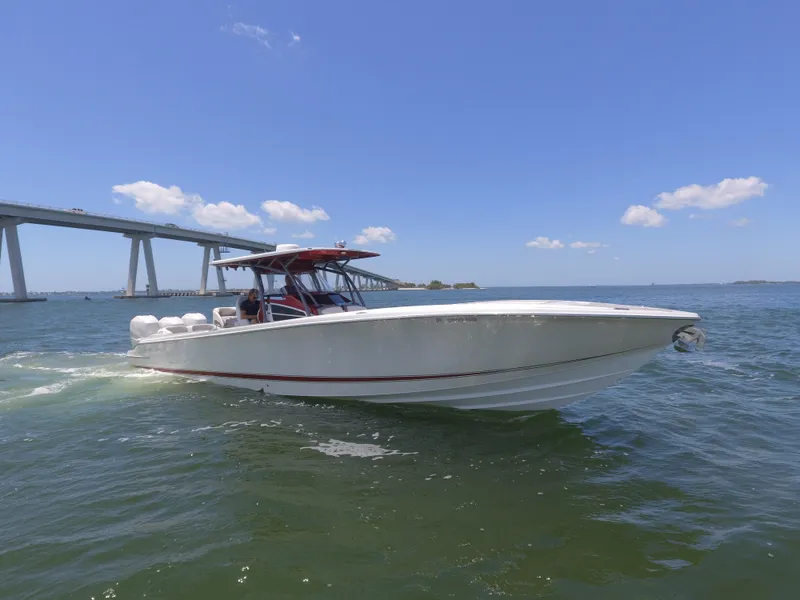 Slide: The Image of 2017 Nor-Tech 390 Sport boat cruising on a sunny day near a bridge. - 29
