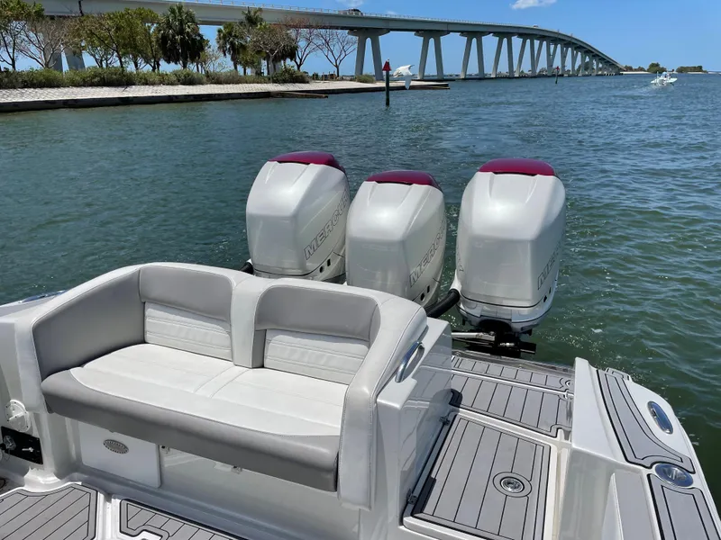 Slide: The Image of 2017 Nor-Tech 390 Sport boat with triple outboard engines on the water. - 30