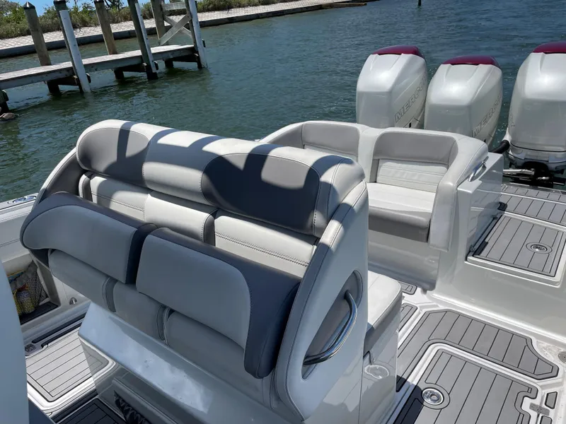 Slide: The Image of 2017 Nor-Tech 390 Sport boat interior with seating and triple outboard engines. - 31