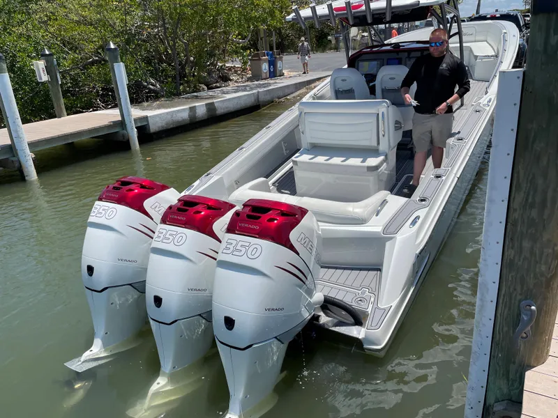 Slide: The Image of 2017 Nor-Tech 390 Sport boat with triple outboard engines docked. - 37