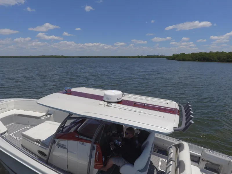 Slide: The Image of 2017 Nor-Tech 390 Sport boat cruising on a sunny day. - 6