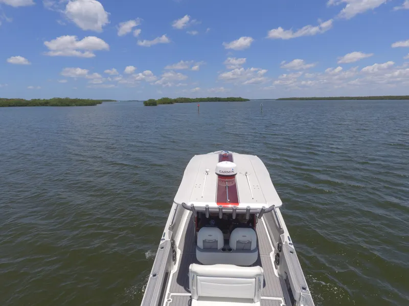Slide: The Image of 2017 Nor-Tech 390 Sport boat cruising on a calm lake under a blue sky. - 7