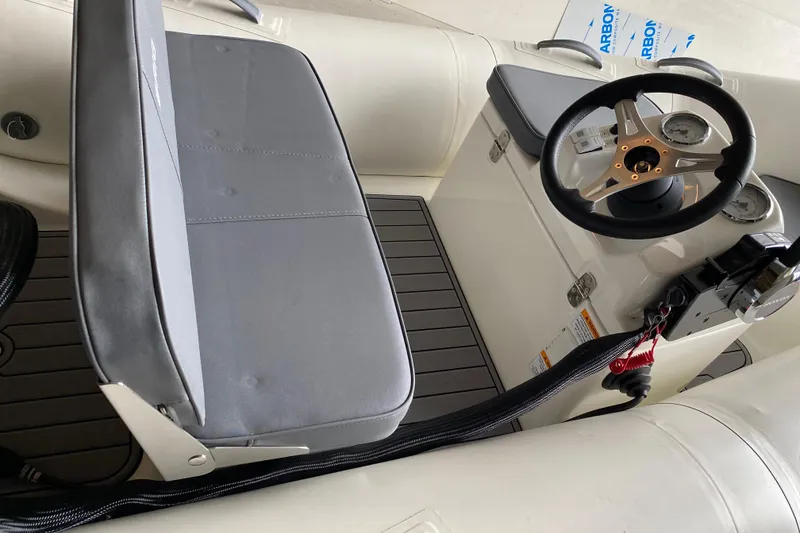 Slide: The Image of 2022 Brig Falcon 330 boat interior with steering wheel and seating. - 10