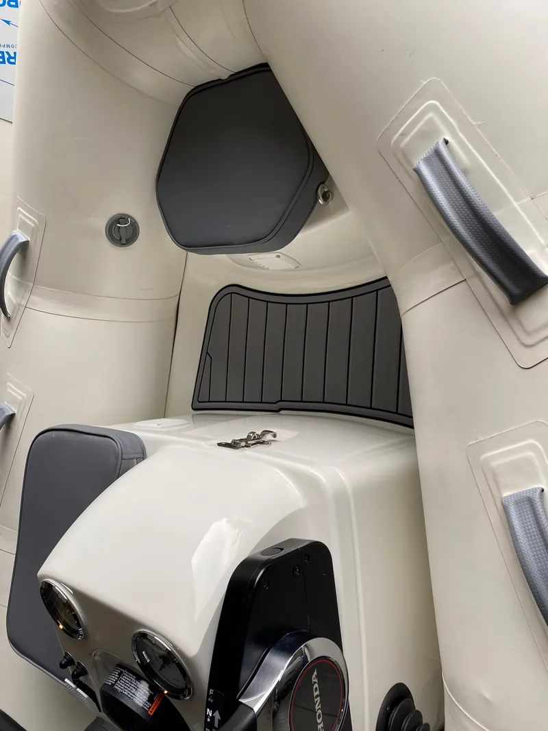 Slide: The Image of 2022 Brig Falcon 330 inflatable boat interior with control panel and seating. - 2